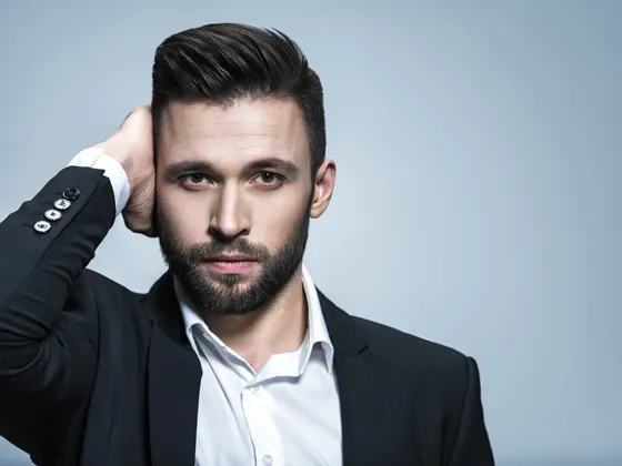 Confident man with a full head of hair after a male hair transplant